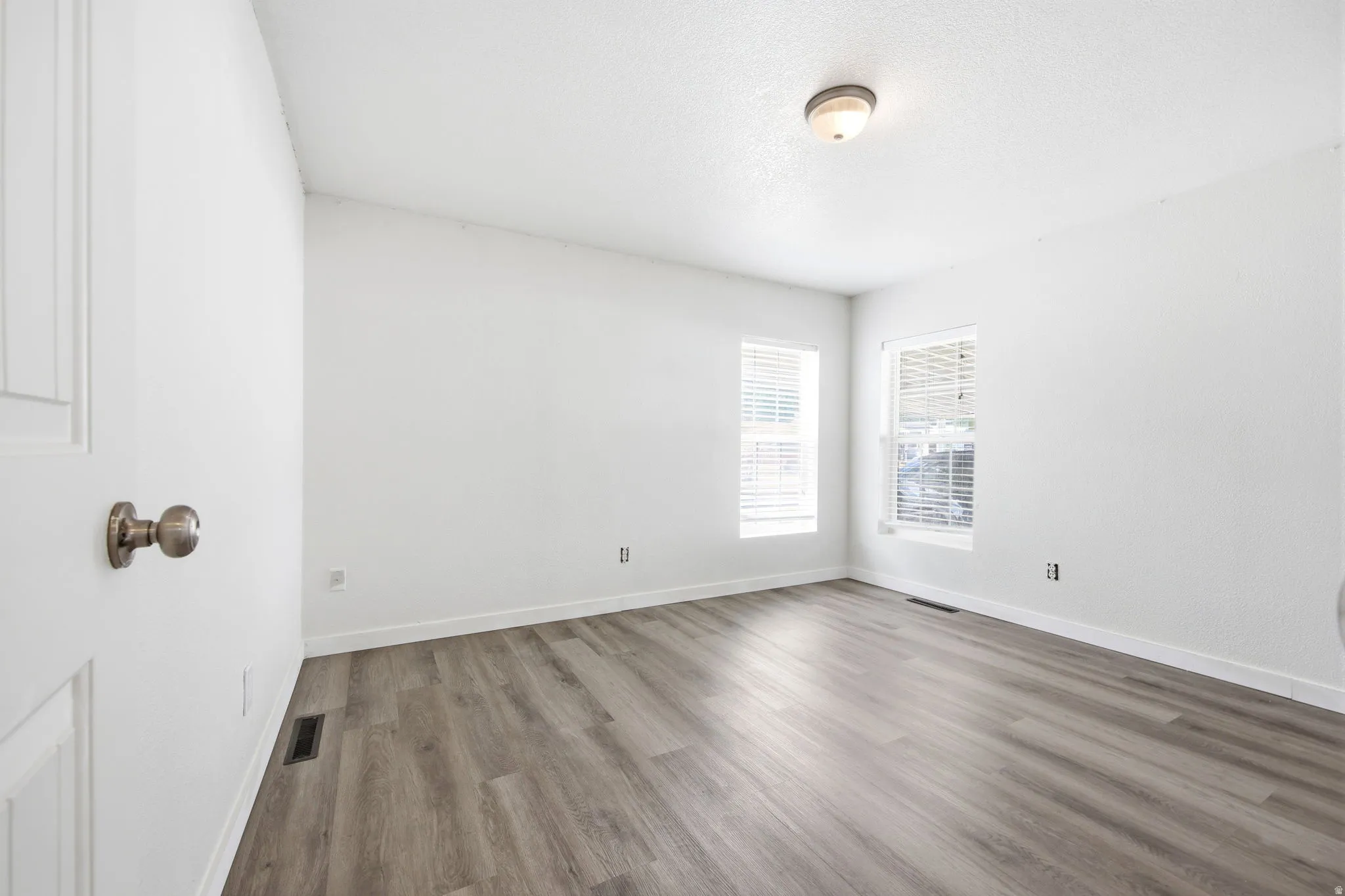 Room featuring light wood-finish flooring and bright white walls