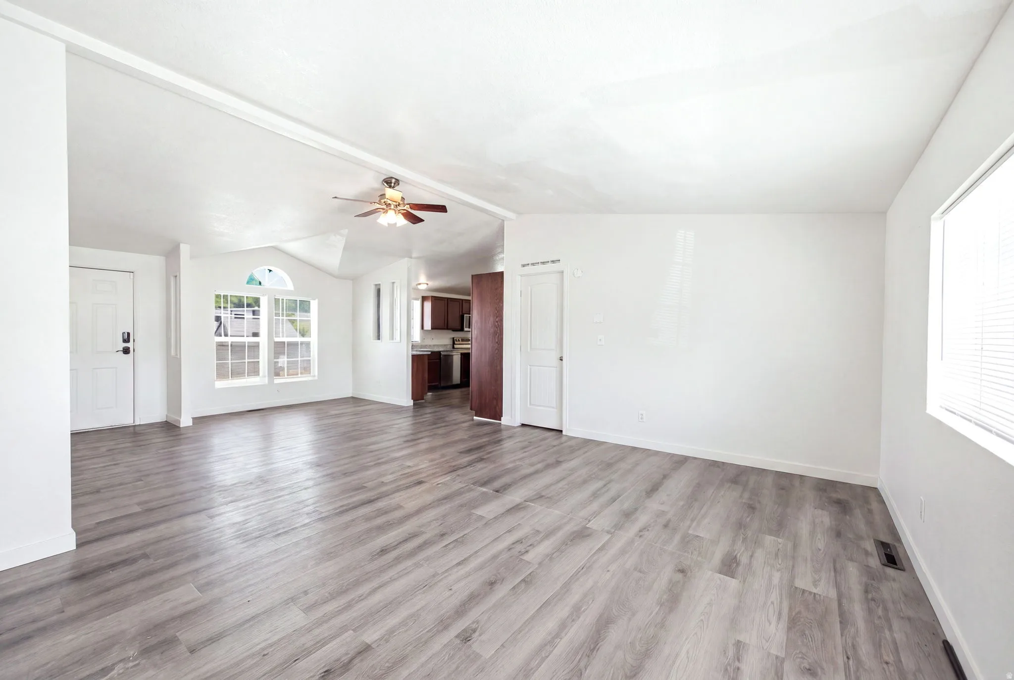 Spacious interior featuring light wood-finish flooring and white walls