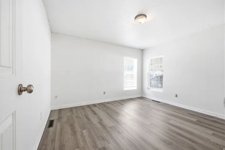 Room featuring light wood-finish flooring and bright white walls