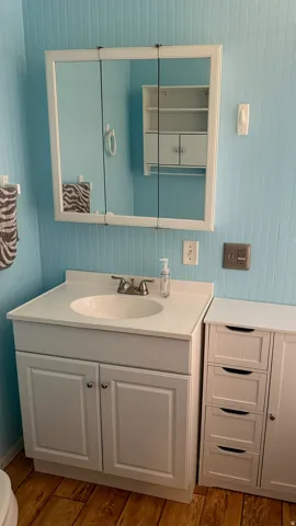 White vanity with an integrated sink and brushed nickel faucet hardware