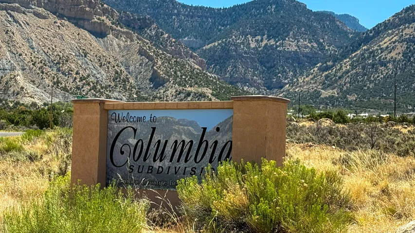 Monument sign for Columbia Subdivision, featuring stucco finish and a stone cap