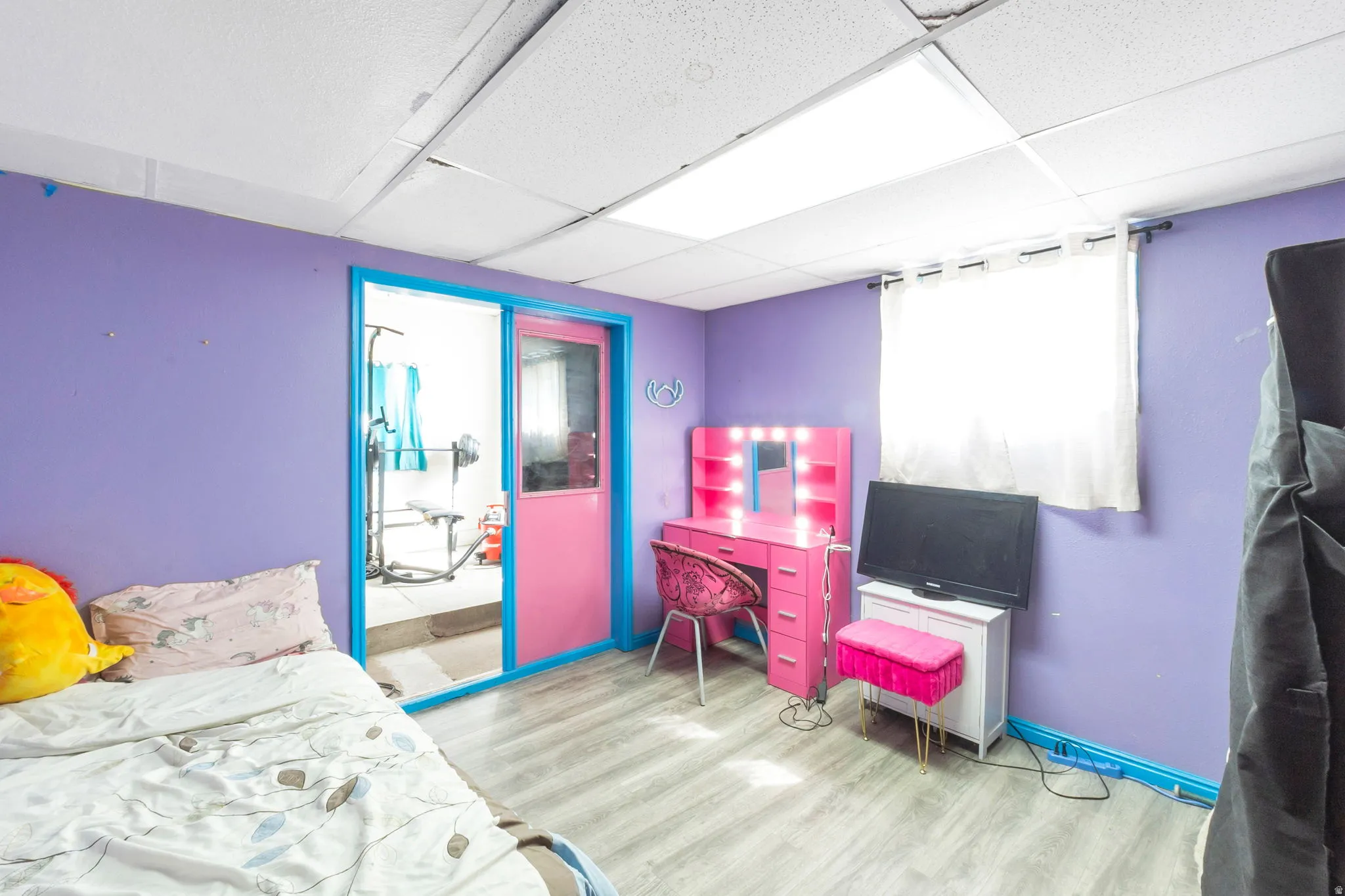 Wood-finish flooring with a drop ceiling featuring recessed lighting