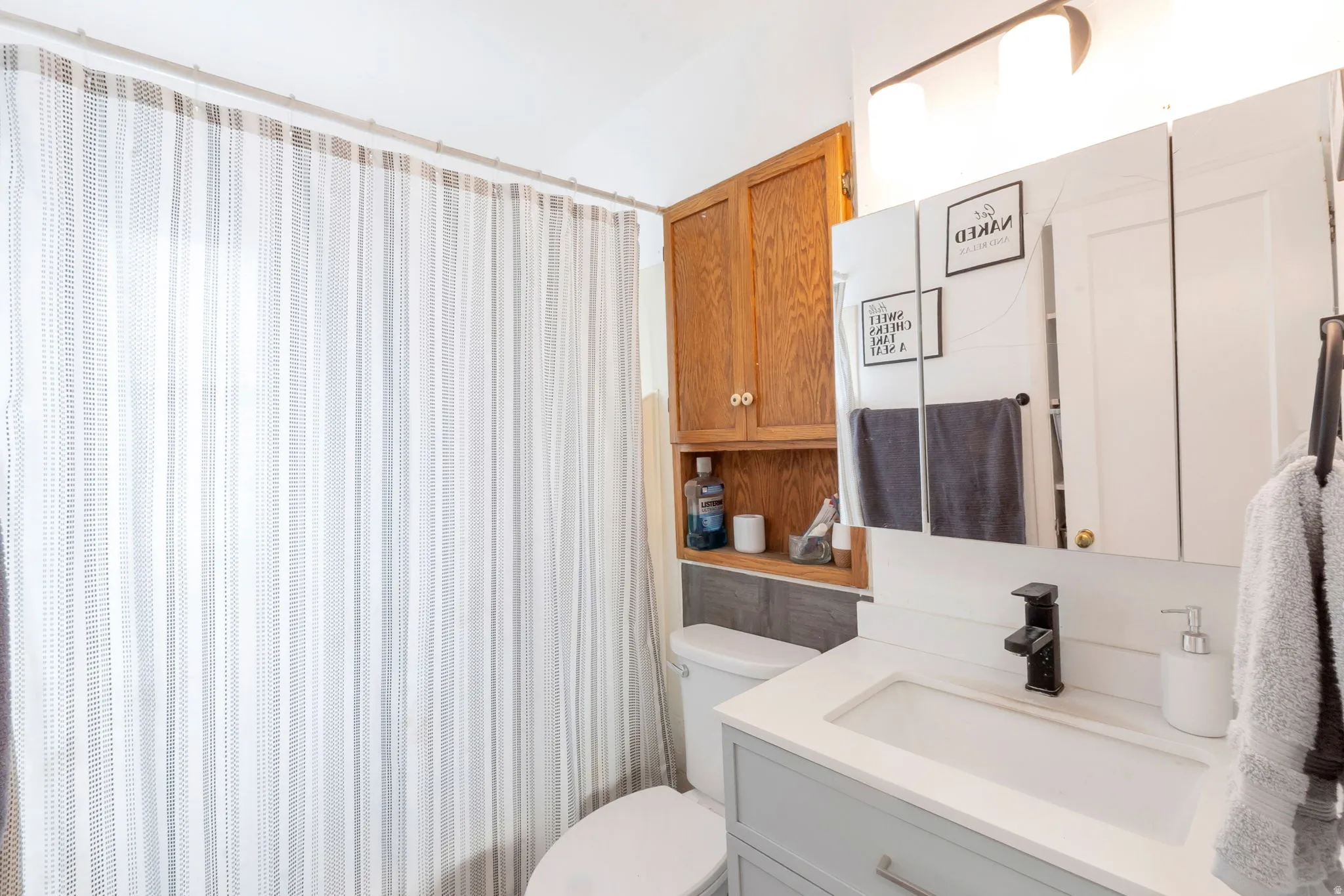 Vanity with integrated sink and matte black faucet