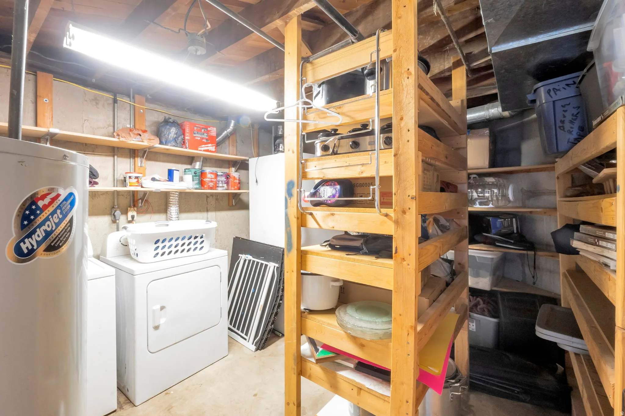 Laundry area with a water heater, washer, and dryer