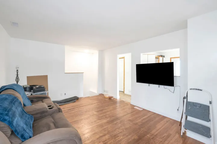 Wood-finish flooring, white painted walls, and an interior pass-through window