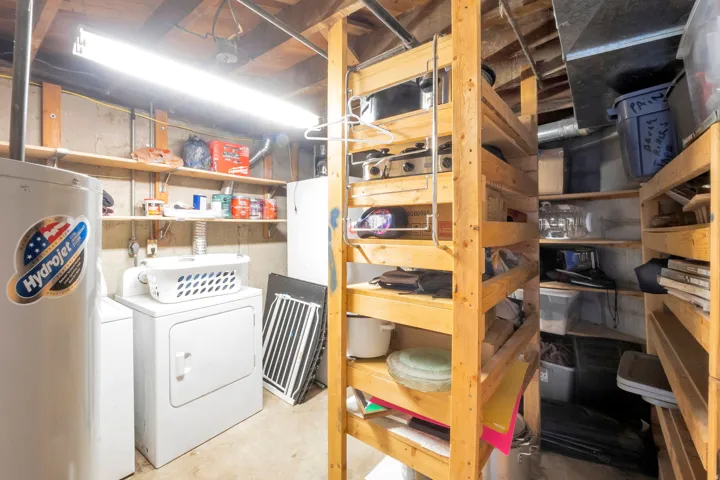 Laundry area with a water heater, washer, and dryer