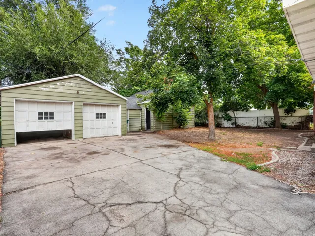 Two-car detached garage with panel doors and window inserts