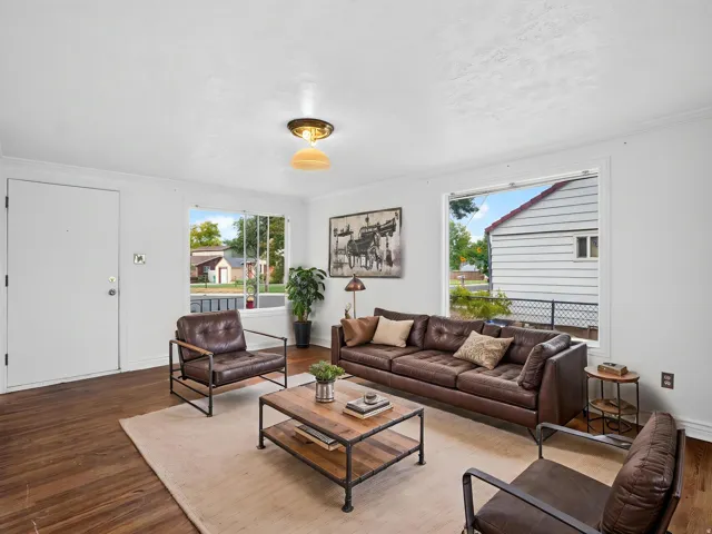 *Virtually Staged* Living area featuring wood-finish flooring, white walls, and a recessed ceiling light fixture