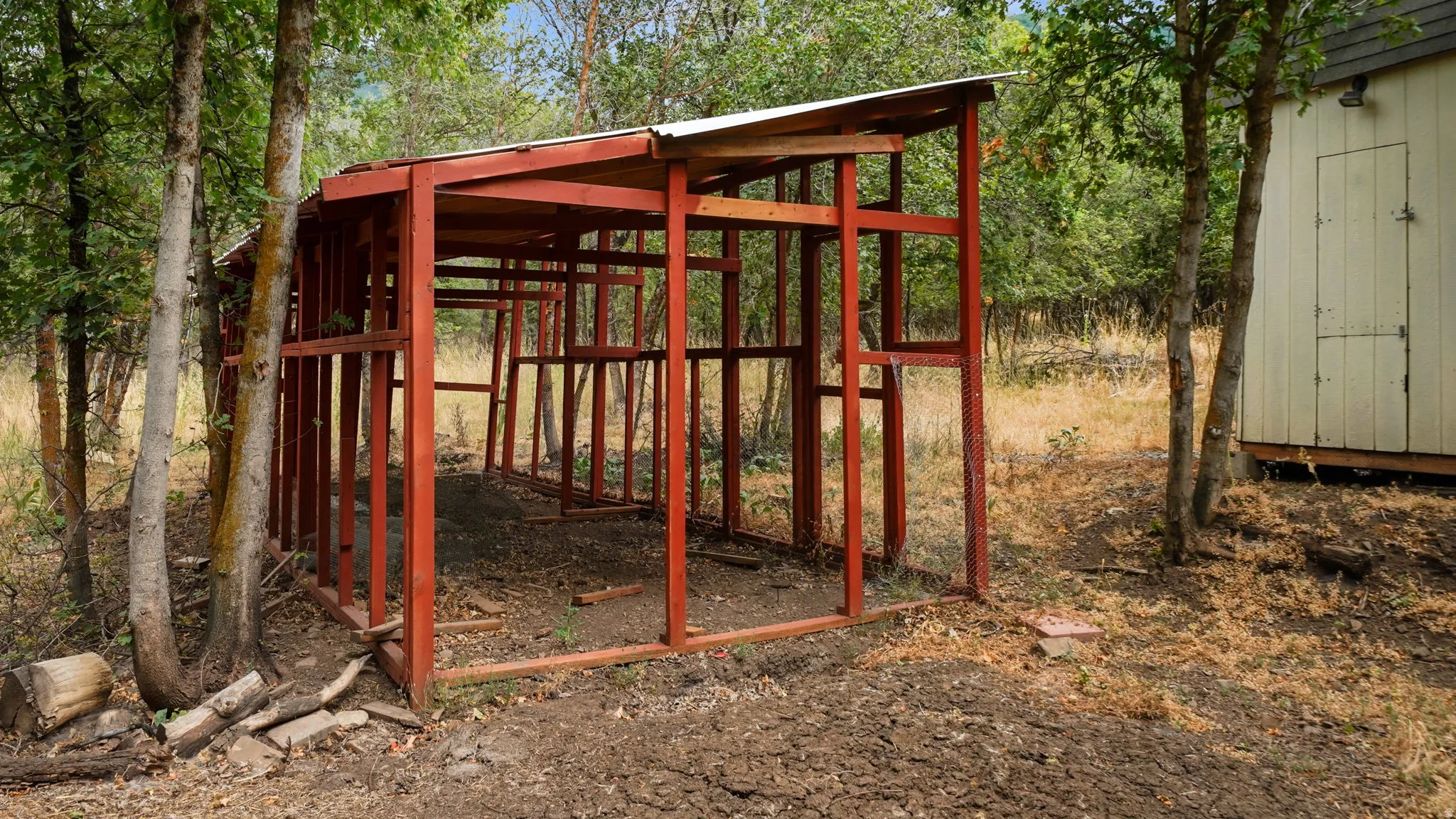 Outdoor structure with exposed wood framing and a partial roof, offering potential for customization
