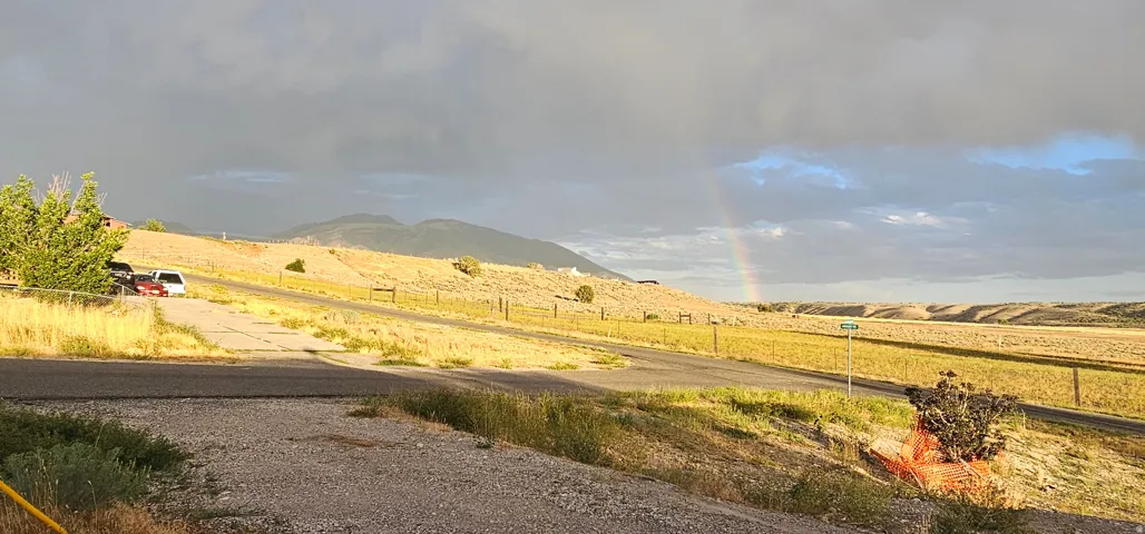 Expansive landscape featuring rolling hills and distant mountains