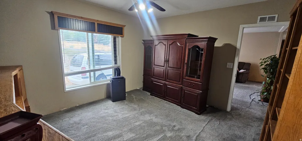 Room featuring neutral wall tones and textured carpeting