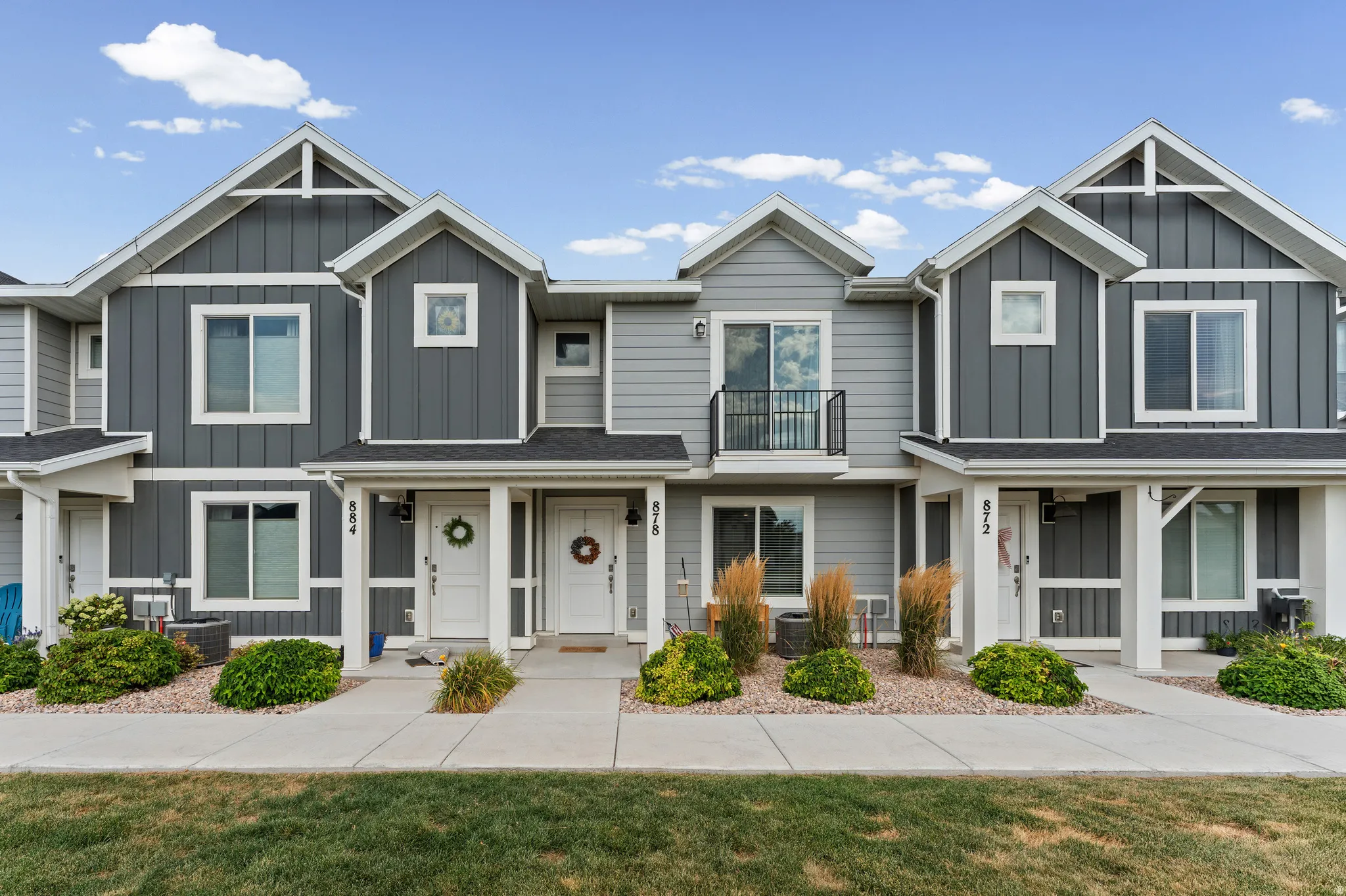 Contemporary multi-unit residence featuring a dark gray and light gray facade with white trim