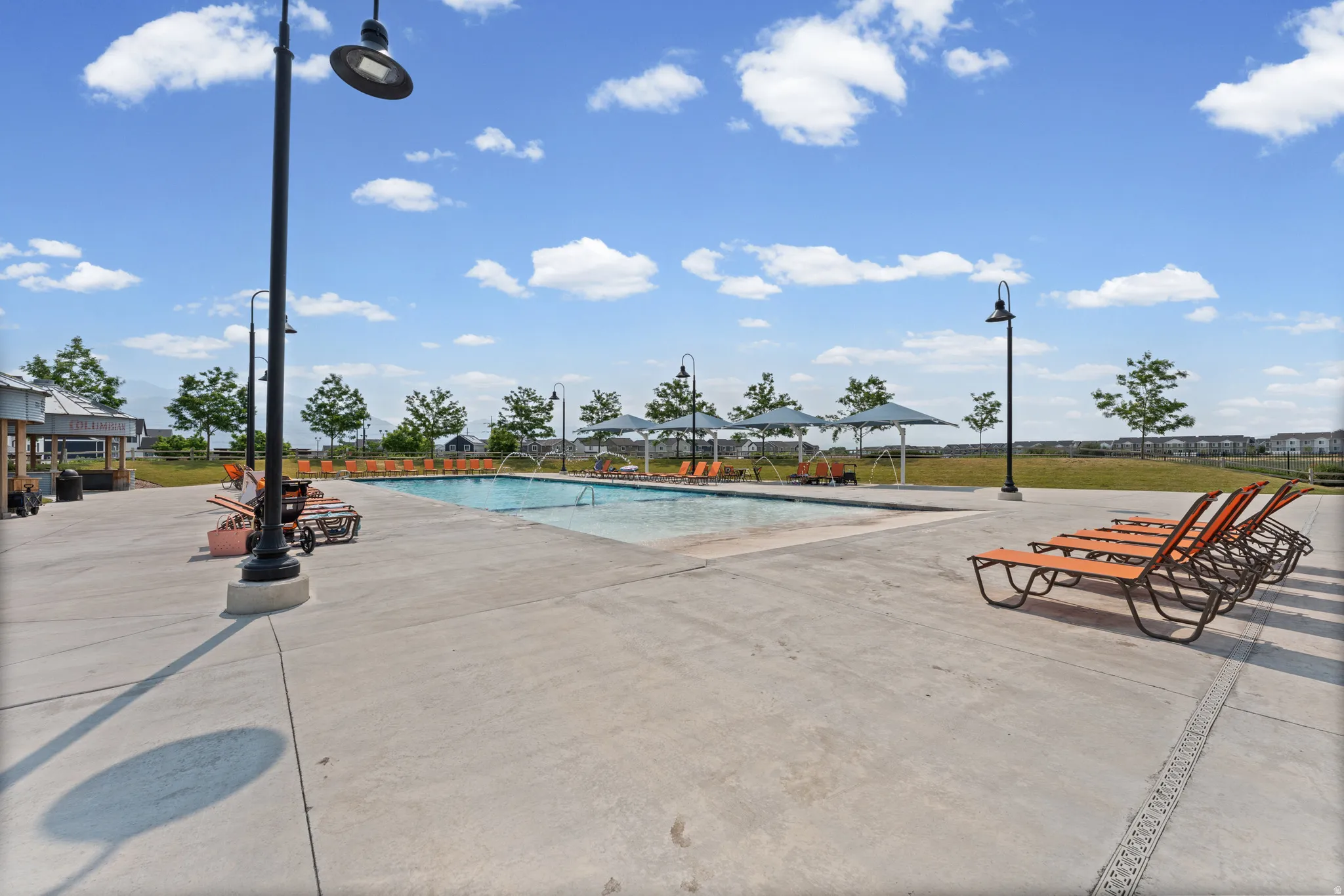Expansive outdoor pool area with substantial concrete decking