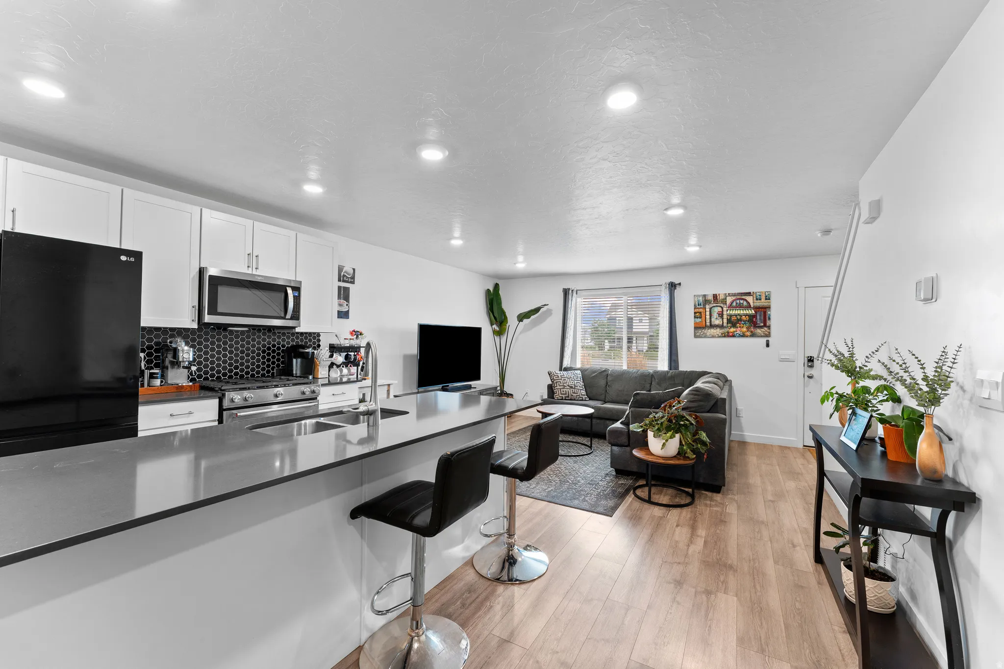 Open-concept living area featuring wood-finish flooring