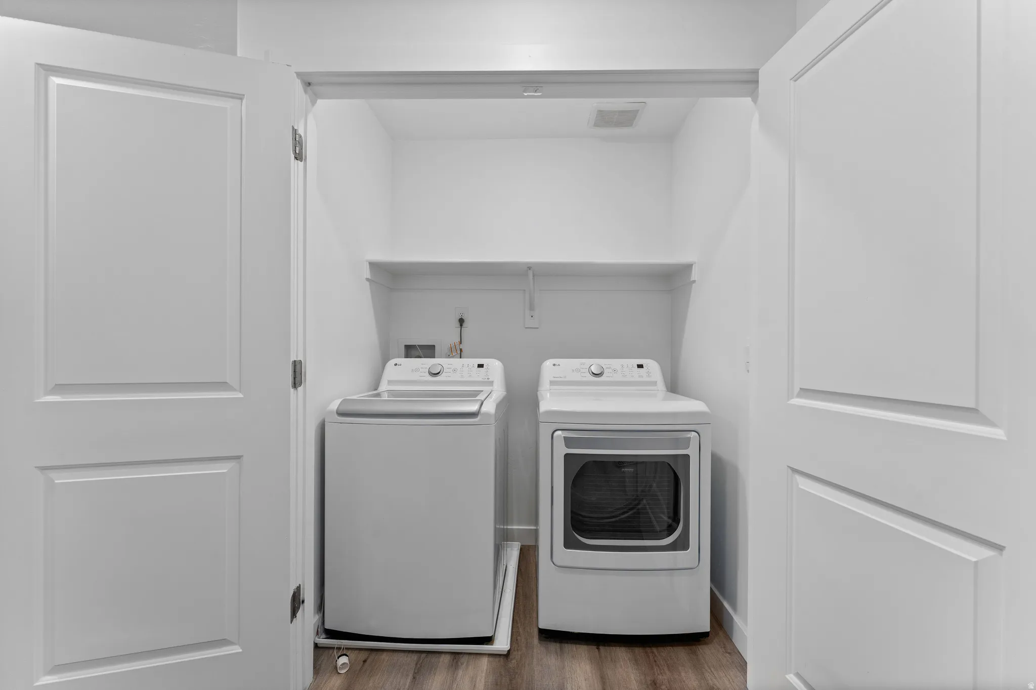 Dedicated laundry closet featuring a top-load washer and front-load dryer