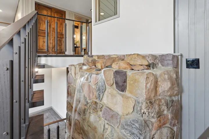 Stacked stone water feature with integrated lighting. Viewable from entry, main floor and basement.