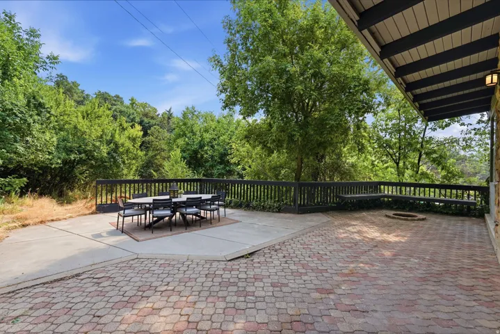 Expansive multi-level patio featuring a paver stone area and a concrete slab