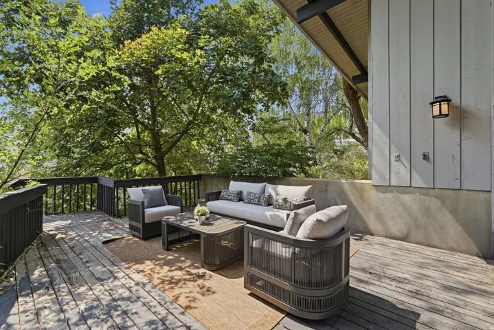 Expansive outdoor deck featuring wood flooring and dark railings