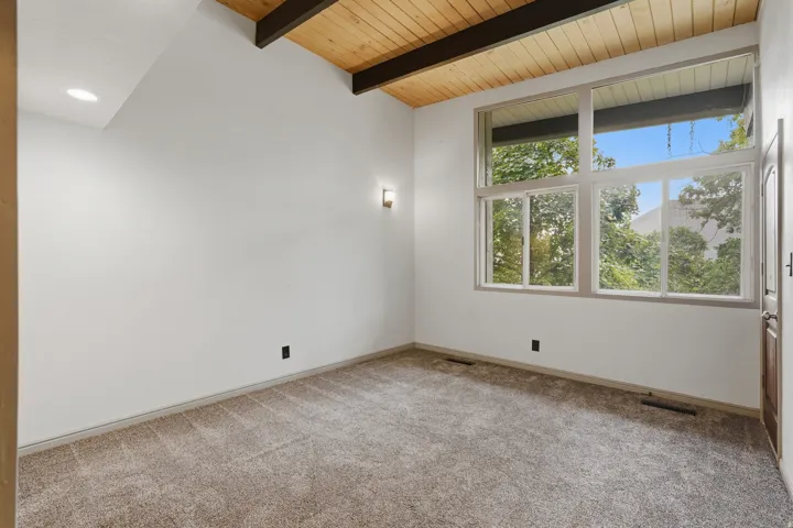 Vaulted wood-paneled ceiling with exposed beams