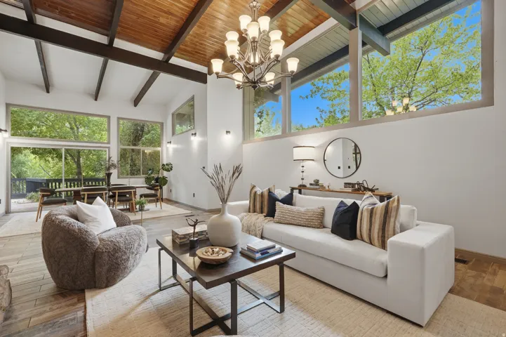 Vaulted wood-paneled ceilings with exposed beams, expansive windows