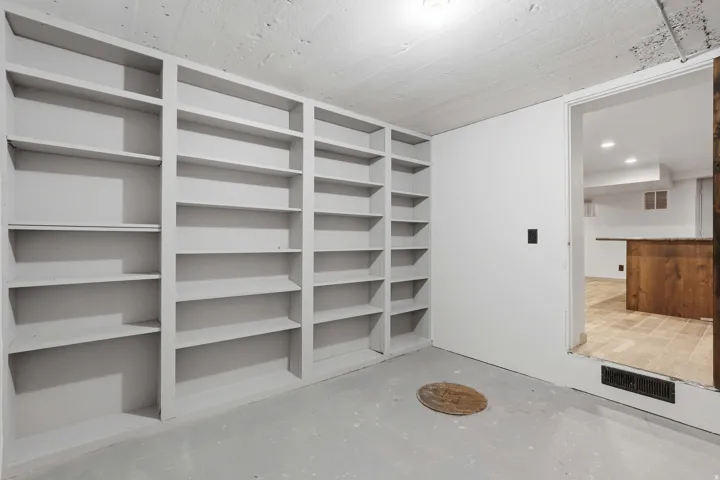 Extensive built-in shelving provides ample storage off the basement kitchen.