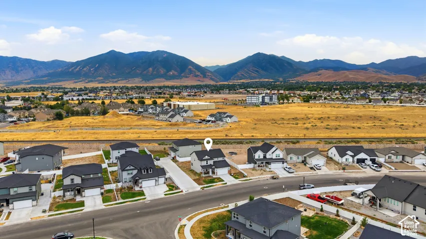Aerial perspective showcasing a residential area with a mountain range backdrop