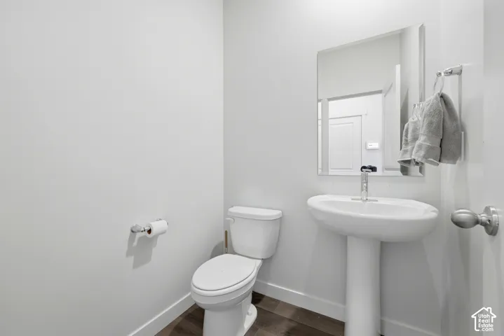 Pedestal sink with chrome faucet and rectangular mirror