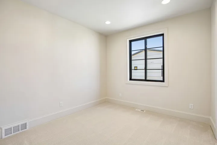 Neutral tone walls with recessed lighting