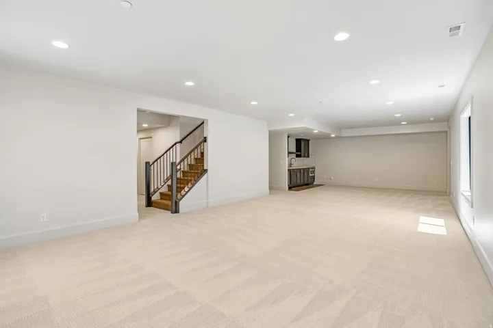 Spacious lower level featuring plush patterned carpeting and recessed lighting