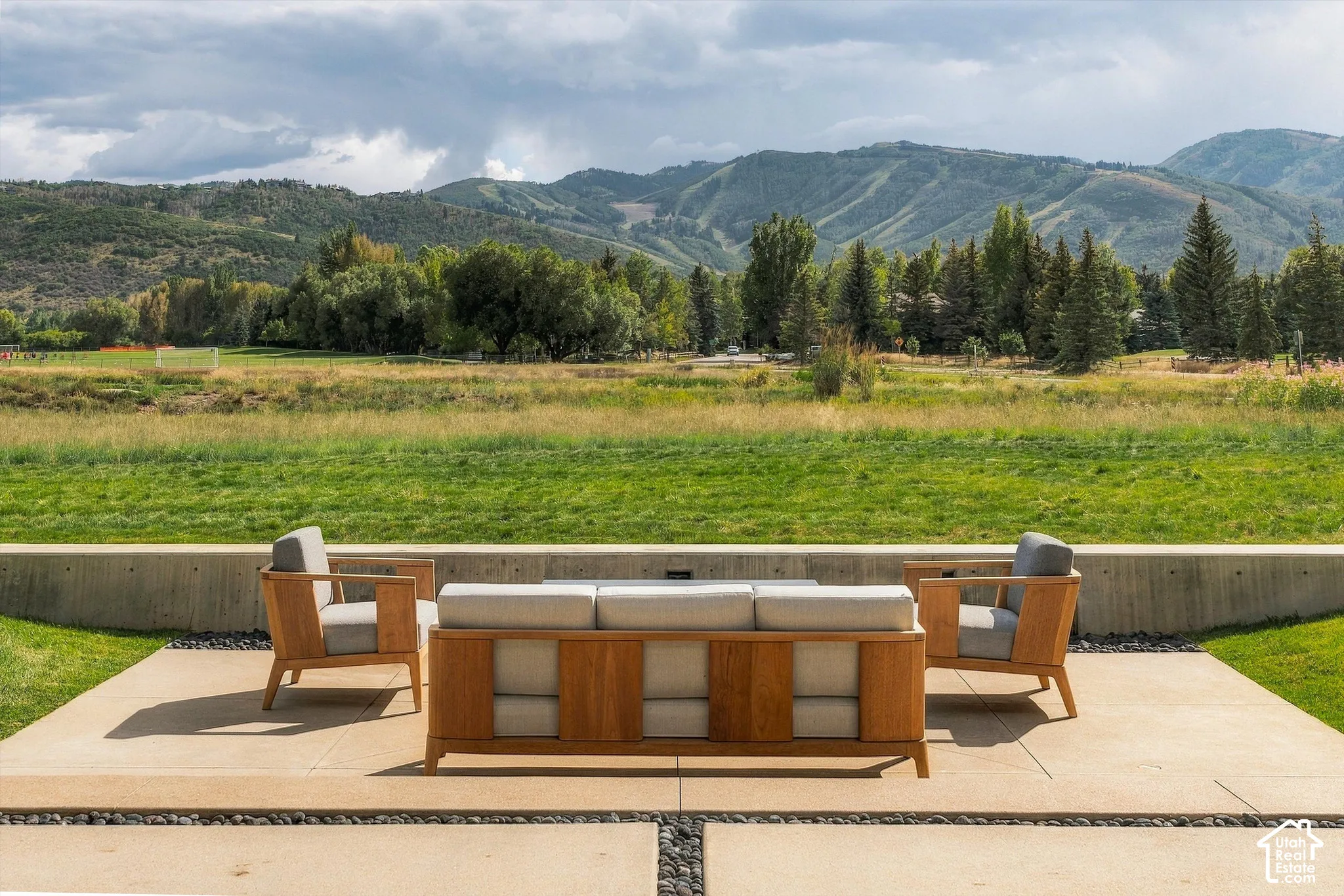 Expansive exterior patio with large format pavers and decorative stone accents