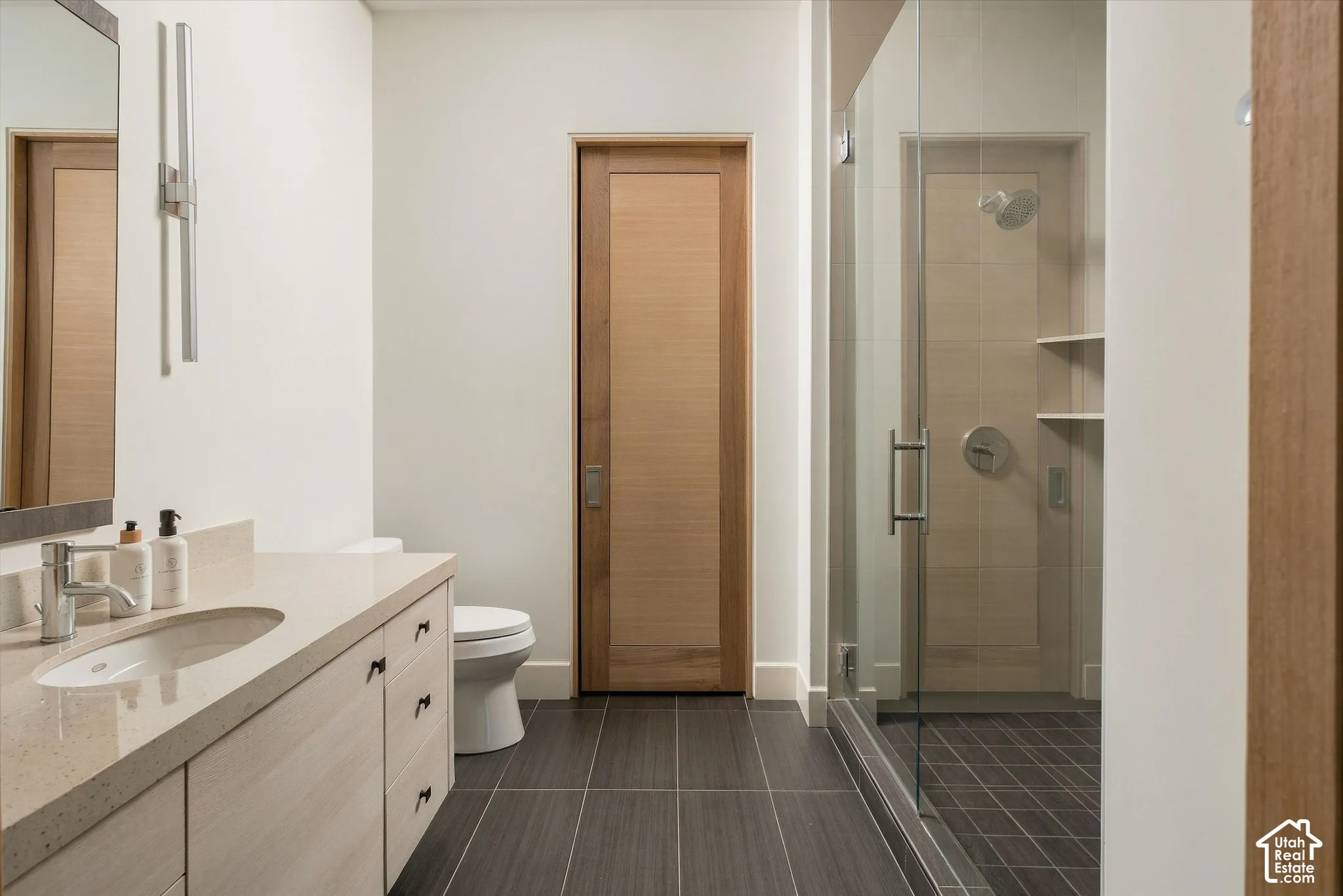 Floating vanity with an integrated sink, polished chrome faucet, and ample storage