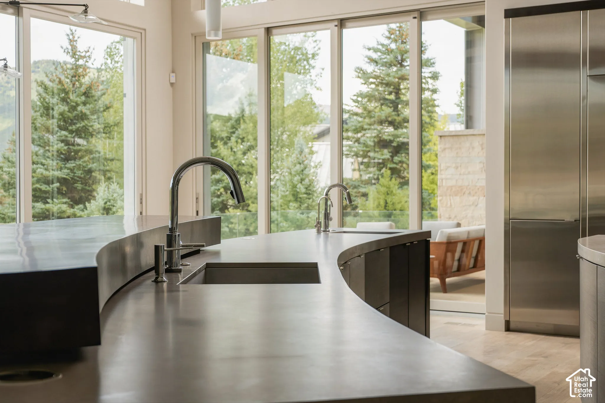 Curved island design with integrated sink and contemporary faucet