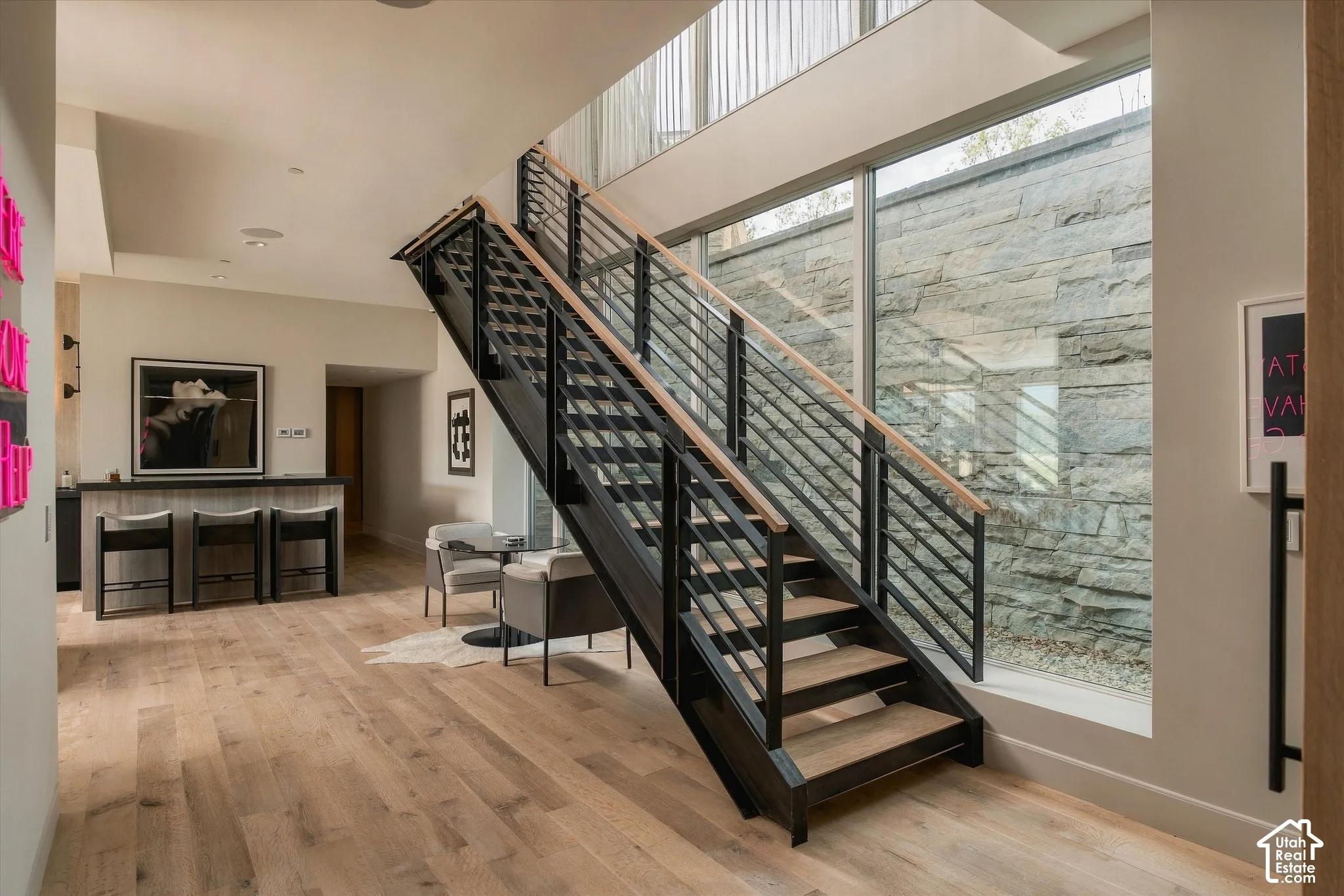 Modern open staircase with metal railings and wood-finish treads