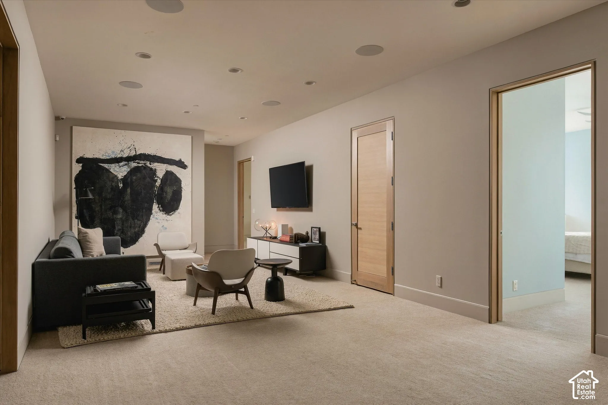 Recessed ceiling lighting, wood-finish doors, and wall-mounted television