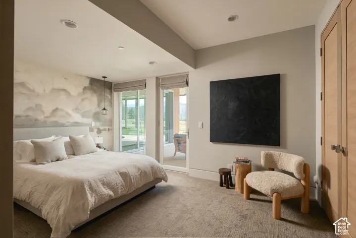 Recessed ceiling lighting, full-height sliding glass doors, neutral wall paint, and light wood-finish paneled doors