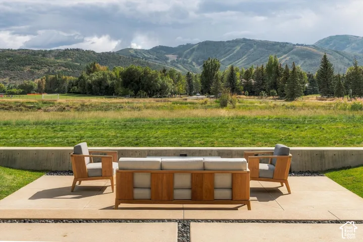 Expansive exterior patio with large format pavers and decorative stone accents