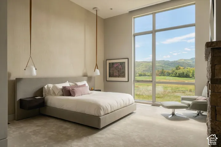Expansive floor-to-ceiling windows, high ceilings, and recessed lighting