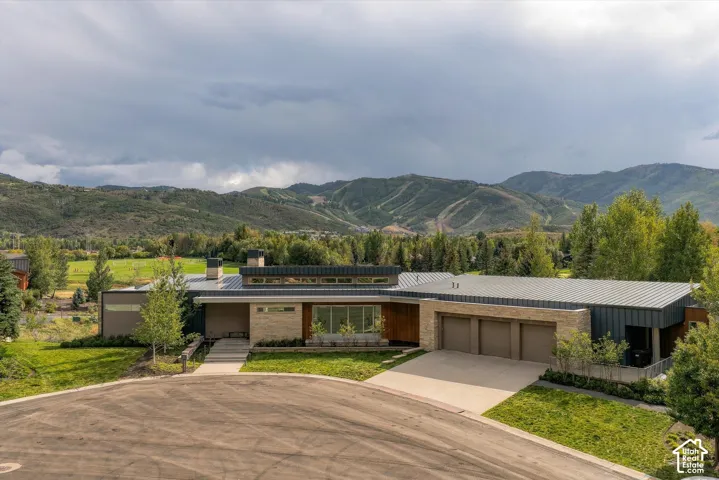 Contemporary architectural design with a natural stone and vertical siding exterior