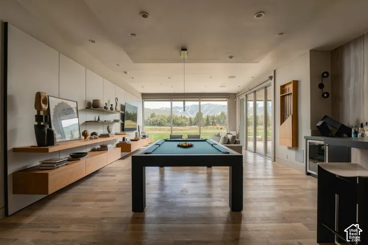 Wood-finish flooring throughout, with a built-in media console and floating shelving