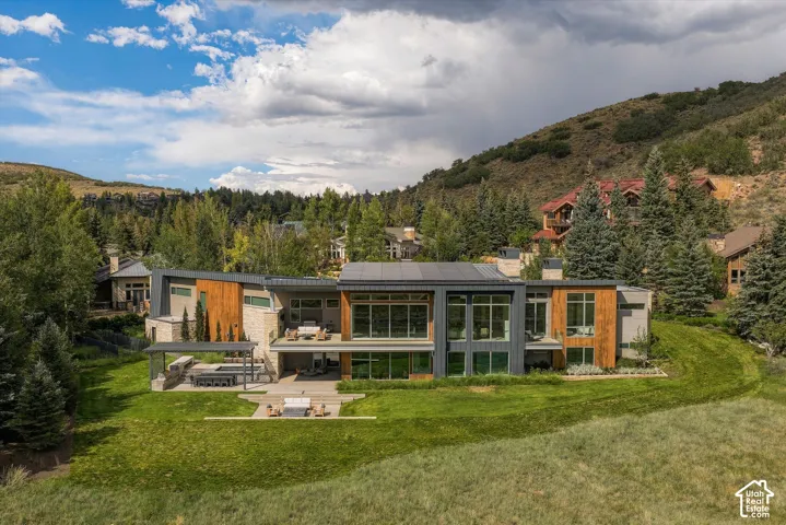 Contemporary architecture featuring extensive glazing, stone, and wood paneling