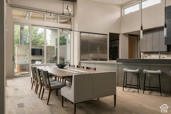 Spacious dining area with wood-finish flooring, sliding glass doors, and clerestory windows