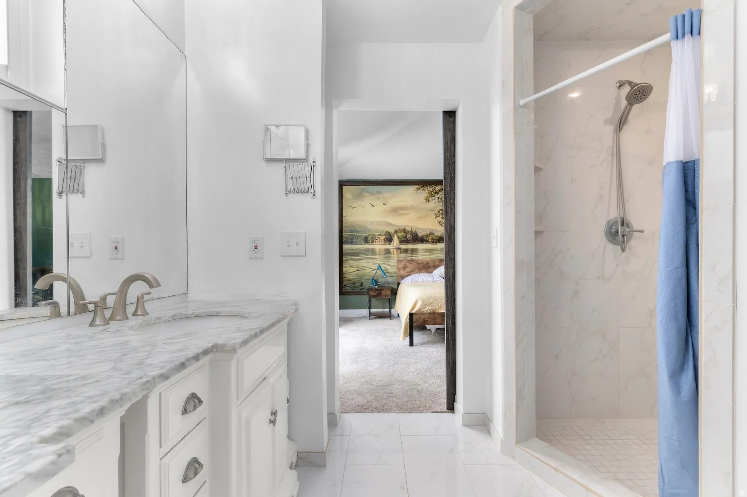 Master Bathroom featuring a white vanity with an integrated sink, a light-toned stone countertop, and brushed nickel fixtures