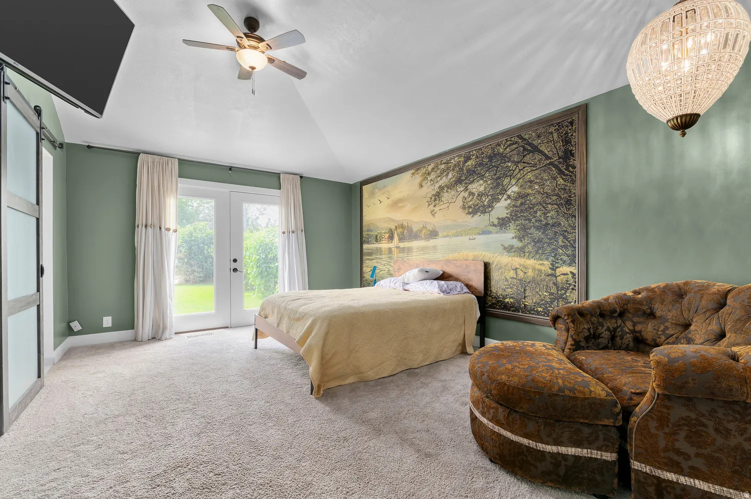 Spacious Master featuring vaulted ceilings, light-toned carpeting, and a ceiling fan