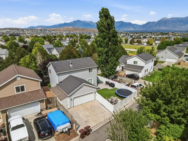 Aerial perspective showcasing a residential neighborhood with distant mountain ranges