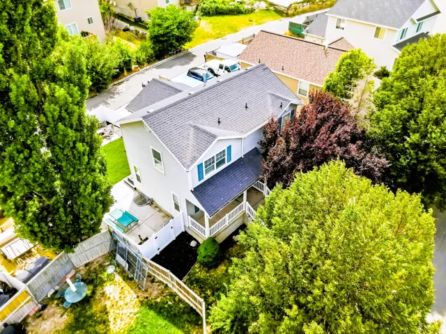 Two-story residence featuring a gabled roof and light gray siding