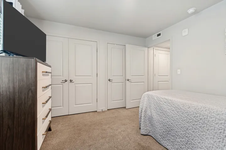 Neutral wall paint and carpeted flooring define this interior space
