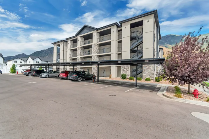 Multi-story building featuring stacked balconies and stone veneer accents