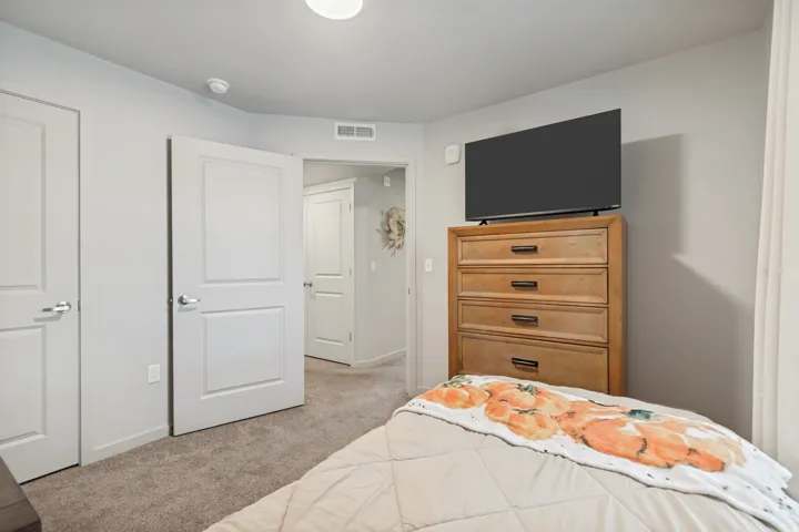 Neutral gray walls with white trim, two panel interior doors, recessed ceiling lighting, and light brown carpeting