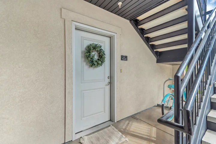 Entryway featuring a paneled door with a decorative wreath
