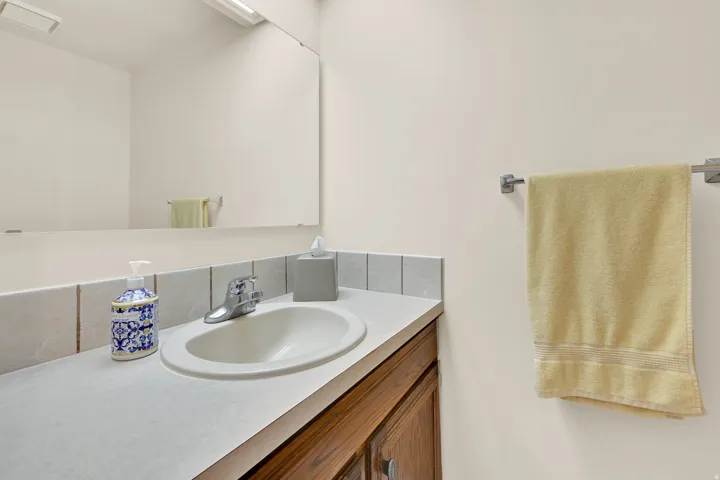 Bathroom vanity featuring an integrated oval sink with a chrome faucet